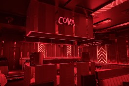 Main room and DJ booth in red architectural lighting at COVA Club Paris 