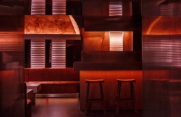 Warm amber lighting and lounge seating at Lowkey Paris beneath the Palais-Royal 