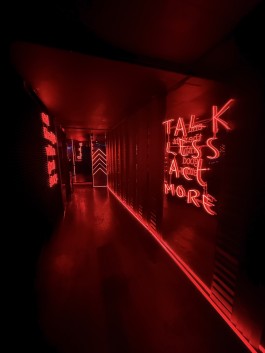 Red neon corridor and mirrored surfaces at COVA Club Paris