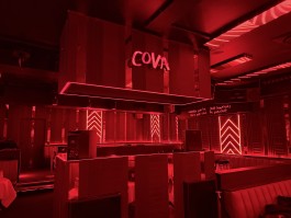 Main room and DJ booth in red architectural lighting at COVA Club Paris