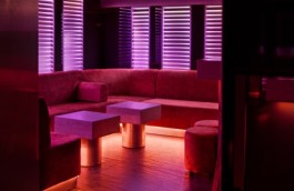 Lounge seating and pink illuminated panels at Lowkey Paris